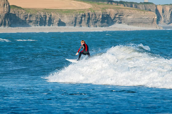 Surfing at Dunraven Bay